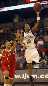 Cotelia Bond-Young, right, drives past N.C. State forward Khadijah Whittington.