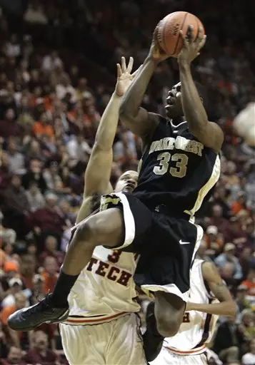 Trent Strickland drives to the basket in front of Virginia Tech guard Shawn Harris during first half.