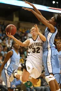 Deirdre Naughon drives to the basket agaisnt UNC's LaToya Pringle as Rashanda McCants trails the play.