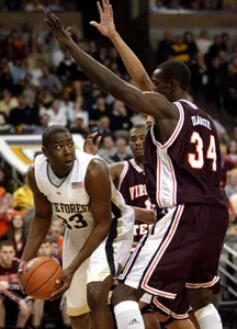 Trent Strickland is guarded under the basket by Virginia Tech's Cheick Diakite.
