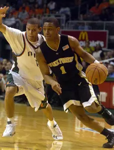 Justin Gray drives despite pressure from Miami's Denis Clemente during the second half.