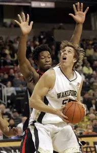 Wake Forest's Kyle Visser (55) eyes the basket as Georgia's Albert Jackson defends in the first half of a basketball game in Winston-Salem, N.C., Saturday, Dec. 2, 2006. (AP Photo/Rick Havner)