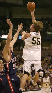 Kyle Visser shoots over Richmond's Drew Crank in the Demon Deacons' 72-59 win. (AP Photo/Winston-Salem Journal, Bruce Chapman)