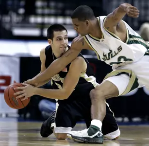Michael Drum keeps the ball away from South Florida's Jesus Verdejo during the first half. (AP photo)