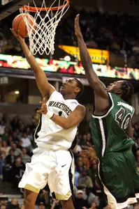 Wake Forest's Justin Gray, left, scores against Charlotte's Jerell Jamison (40) during the first half of a college basketball game in Winston-Salem, N.C., Saturday, Feb.11, 2006. (AP Photo/Lynn Hey)