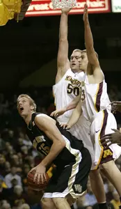 Wake Forest center Kyle Visser, left, looks to make a shot in front of Minnesota center Spencer Tollackson (50) and guard Jamal Abu-Shamala during the first half in Minneapolis.