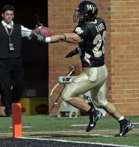 Kevin Harris stretches out as he runs for a touchdown in the first quarter. (AP Photo/Chuck Burton)