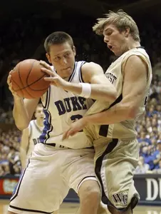 Wake Forest's Kyle Visser guards Duke's Josh McRoberts in the first half. (AP Photo/Gerry Broome)