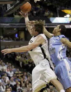 Wake Forest's Kyle Visser drives past North Carolina's Surry Wood in the first half. (AP Photo/Chuck Burton)