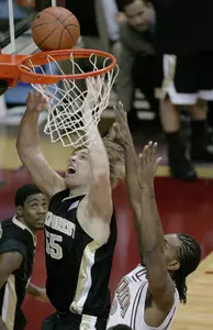 Wake Forest's Kyle Visser, left, scores in the second half as Florida State's Ryan Reid, right, defends. (AP Photo/Phil Coale)