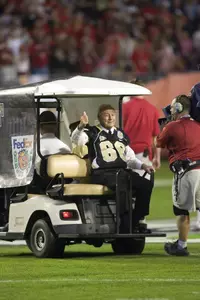 Arnold Palmer makes his way out to midfield for the coin toss at the Orange Bowl.