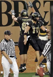 Wake Forest quarterback Riley Skinner (11) and John Tereshinski (88) celebrate Tereshinski's game-tying touchdown in the fourth quarter of their 31-24 overtime win over Maryland in a football game in Winston-Salem, N.C., Saturday, Sept. 22, 2007. (AP Photo/Chuck Burton)