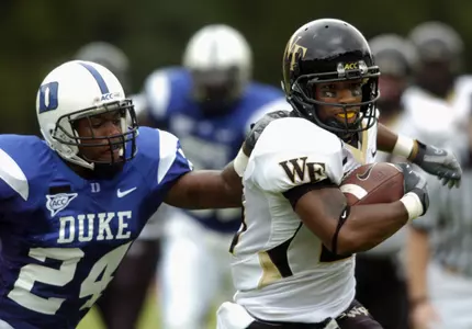 Kenny Moore pulls away from Duke's Glenn Williams in the first half Saturday. (AP Photo/Sara D. Davis)