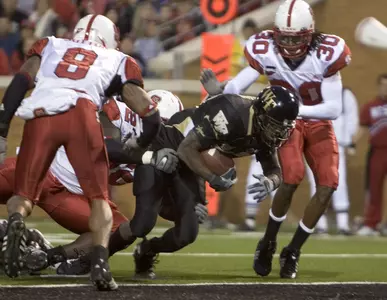 Wake Forest's Josh Adams slips through North Carolina State's defense to score in the second quarter.