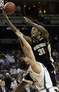 Wake Forest's Jamie Skeen (31) drives against Charlotte's Ian Andersen, left, during the first half. (AP Photo/Chuck Burton)