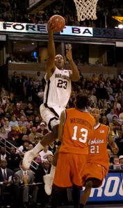 Wake Forest's James Johnson (23) goes over Virginia Tech's Deron Washington (13) during the first half