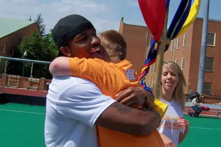 Kenny Moore gets a hug from a Special Olympics athlete.