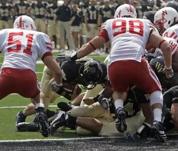 Wake Forest's Brett Hodges, center, runs for a one-yard touchdown as Nebraska's Bo Ruud (51) and Zach Potter (89) defend in the second quarter. (AP Photo/Chuck Burton)