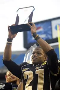 Kenneth Moore hoists his MVP trophy after Wake Forest defeated Connecticut 24-10 in the Meineke Bowl. (AP Photo/Nell Redmond)