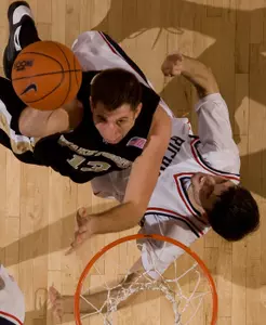 Chas McFarland shoots over top of Richmond's Conor Smith. (AP)