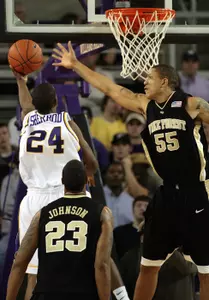 Tony Woods prepares to block the shot of East Carolina's Jontae Sherrod as Wake's James Johnson looks on. (AP)