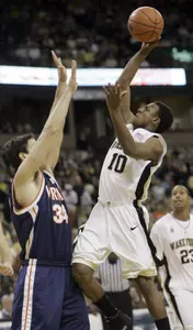 Ishmael Smith shoots over Virginia's Ryan Pettinella. (AP Photo/Chuck Burton)
