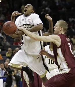 Jeff Teague is fouled by Florida State forward Jordan Demercy as he drives to the basket in the first half. (AP Photo/Gerry Broome)