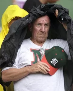 A Miami fan shields himself from the rain
