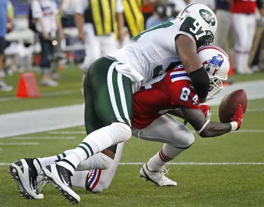 Calvin Pace makes a tackle on New England receiver Deion Branch.