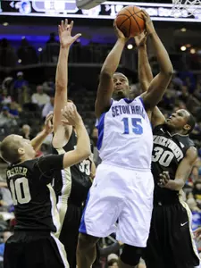 Seton Hall forward Herb Pope is defended by Wake Forest's Travis McKie (30), Carson Desrosiers (33) and Chase Fisher (10).