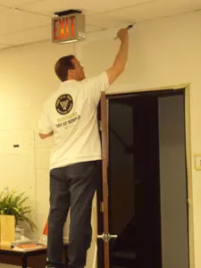 Athletic Director Ron Wellman paints a wall at the Prosperity Center in Winston-Salem