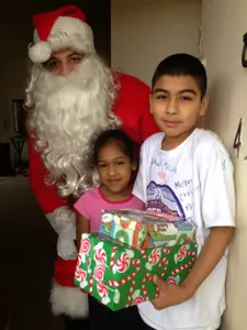 Football player Will Smith dressed up as Santa to deliver gifts through the Santa's Helper program