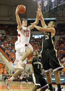 Carson Desrosiers looks to block the shot of Clemson's Catalin Baciu in last month's meeting at Littlejohn Coliseum.