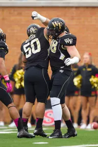 Defensive linemen Nikita Whitlock (50) and Zach Thompson celebrate a sack during last week's win over Maryland.
