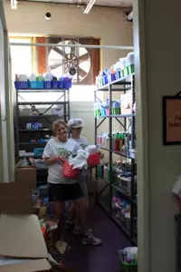 Christy Morgan (Field Hockey) and Pat Tomlinson (Student-Athlete Services) stock the shelves at the Children's Home.