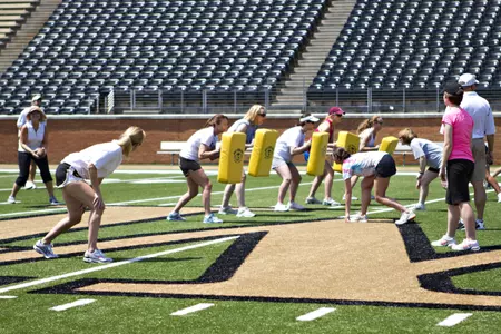 Participants will go through football drills on the turf at BB&T Field.