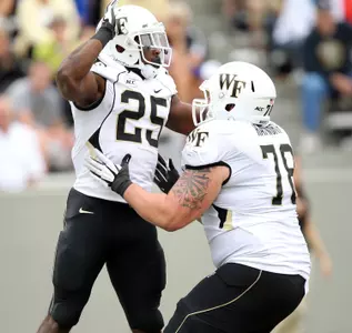 Josh Harris celebrates his rushing touchdown with offensive guard Tyler Hayworth.