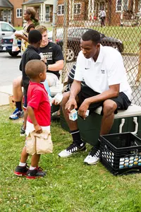 Greg McClinton talks with a young child at the event.
