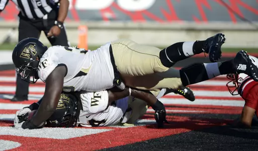 Tylor Harris (top) recovers a Louisville fumble in the endzone for a touchdown.