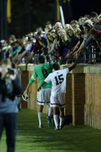 Steven Echevarria (15) and Alec Ferrell (0) thank fans after the Oct. 23 win over Notre Dame.