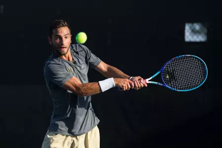 Noah Rubin of the Wake Forest Demon Deacons returns the ball against the George Washington Colonial during Round One action of the 2015 NCAA Men's Tennis Championship at the Wake Forest Tennis Center on May 8, 2015 in Winston-Salem, North Carolina. The Demon Deacons defeated the Colonials 4-0. (Brian Westerholt/Sports On Film)