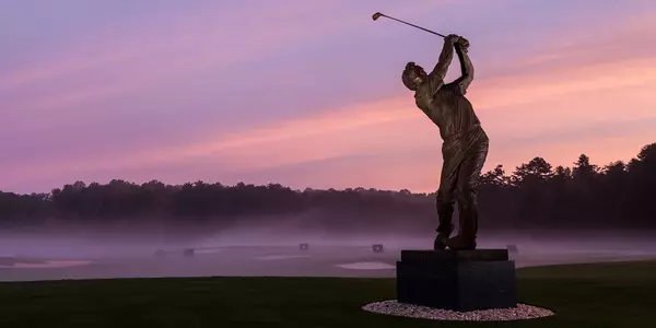 A statue of golf legend Arnold Palmer stands outside the Arnold Palmer Golf Complex on the campus of Wake Forest University on Tuesday, October 15, 2013.
