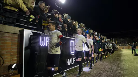 Deacs high fiving fans after a win.