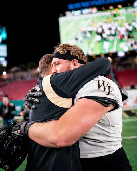 Photo of Michael Jurgens hugging an unidentified staff member
