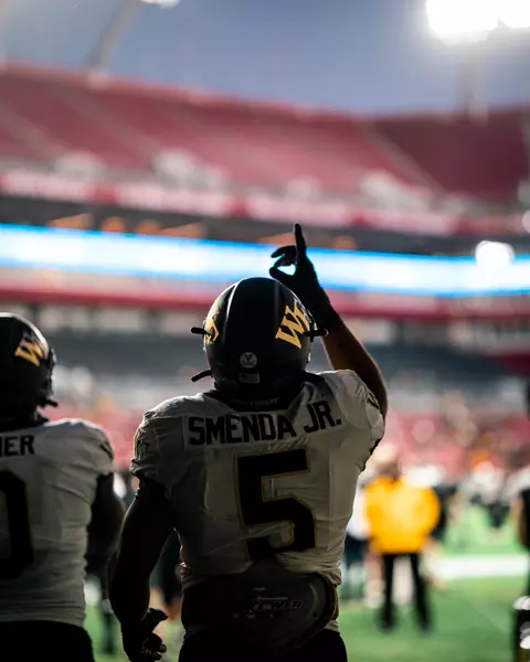 Ryan Smenda Jr. pointing up as he walks into Raymond James Stadium