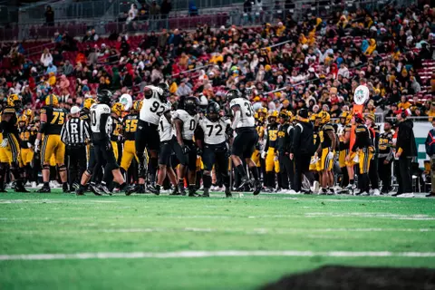 Wake Forest football players celebrating around Tyler Williams after a sack