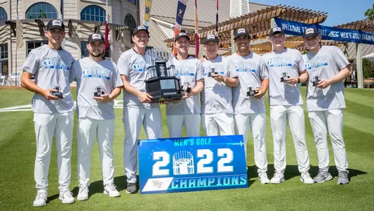 men's golf acc championship team with trophy