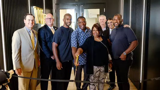 Chris Paul and his family cut the ribbon outside the menâ??s clubhouse.