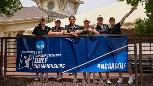 womens golf team with NCAA Championship sign