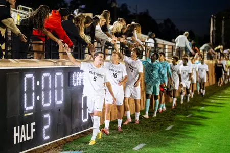 Daniel Krueger, Joel Torbic, Bret Russell, Jonah Mednard, team high-fiving fans